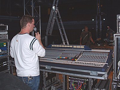 Colin Walker behind his mixing desk during a Delirious? sound check