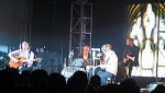 The band's acoustic set in front of a church window