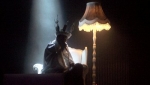 A shadowy figure sits on a throne