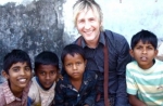 Martin Smith enjoys a photo opportunity with children in Mumbai
