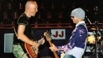 Stu and Jon smiling with their guitars