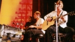 Martin playing acoustically with Jon and Stew in the background