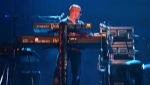 Tim surrounded by keyboards and equipment