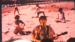 Stu wearing a wig with 'Pursuit' on the video screen